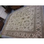 Indo Persian style carpet of all-over floral design with multiple borders on a beige ground, 9ft