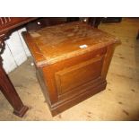 Early 20th Century oak commode with hinged cover and panelled front on plinth base
