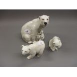 Copenhagen porcelain figure of a polar bear with cubs, together with two Lladro figures of polar