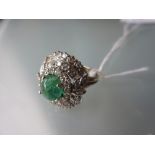 White gold cabochon emerald and multiple diamond cluster ring