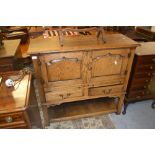 Trevor Lawrence oak side cabinet / aumbry with two fielded panelled doors, two pull-out slides,