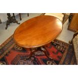 19th Century mahogany oval tilt top table having ring turned and wrythern carved column on