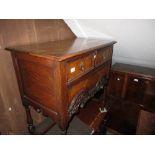 Early to mid 20th Century oak and walnut lowboy with two short and one long drawer on turned