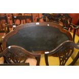 Victorian walnut and marquetry inlaid kidney shaped writing table, the leather inset top on turned