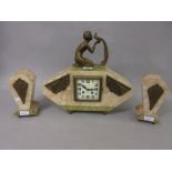 Art Deco beige and green onyx mantel clock with gilt metal mounts, surmounted by a kneeling figure