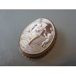 Oval 9ct gold mounted carved shell cameo brooch depicting figures at a water fountain