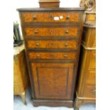 19th Century Continental amboyna and rosewood narrow side cabinet, the moulded top above four