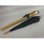 Folding parasol, the wooden handle with gold plated mounts doubling as a case
