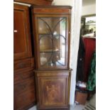 Edwardian mahogany crossbanded and inlaid floor standing corner cabinet, the glazed single door