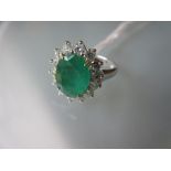 18ct White gold emerald and diamond cluster ring, the emerld approximately 3ct