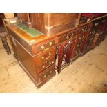 Small late Victorian walnut twin pedestal desk with a tooled leather inset top above nine pedestal