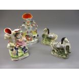 Pair of 19th Century Staffordshire figures of zebras, 6.25ins high (at fault) together with two