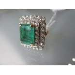 Large yellow gold cluster ring set rectangular emerald banded by two rows of rose cut diamonds (with