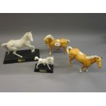 Two Beswick figures of Palomino horses and two white matt glazed Beswick figures on stands, ' Spirit