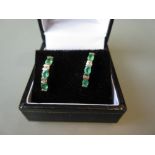 Pair of 14ct yellow gold diamond and emerald set earstuds