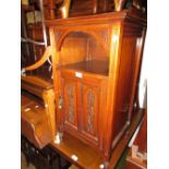 Late Victorian walnut bedside cabinet with an alcove above carved panelled door