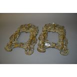 Pair of heavy cast brass photograph frames of figural and foral design in deep relief