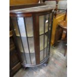 20th Century mahogany bow fronted single door display cabinet on carved cabriole claw and ball