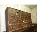 19th Century pine bank of twenty drawers having cast iron cup handles, 26ins high x 4ft wide x