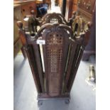 20th Century oak four division stick stand with carved decoration and cane work panels on shaped