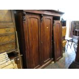 19th Century mahogany three door wardrobe, the moulded cornice above long panel doors with carved