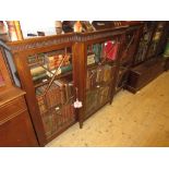 Edwardian mahogany breakfront dwarf bookcase, the moulded top with carved frieze above three