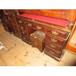 Small late Victorian mahogany twin pedestal desk, the inset top above nine drawers with brass