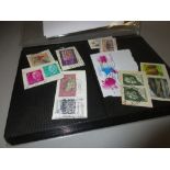 Album containing a collection of approximately five hundred World postage stamps