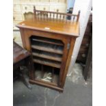 19th Century walnut music cabinet having spindle gallery top above a single door (lacking glass),