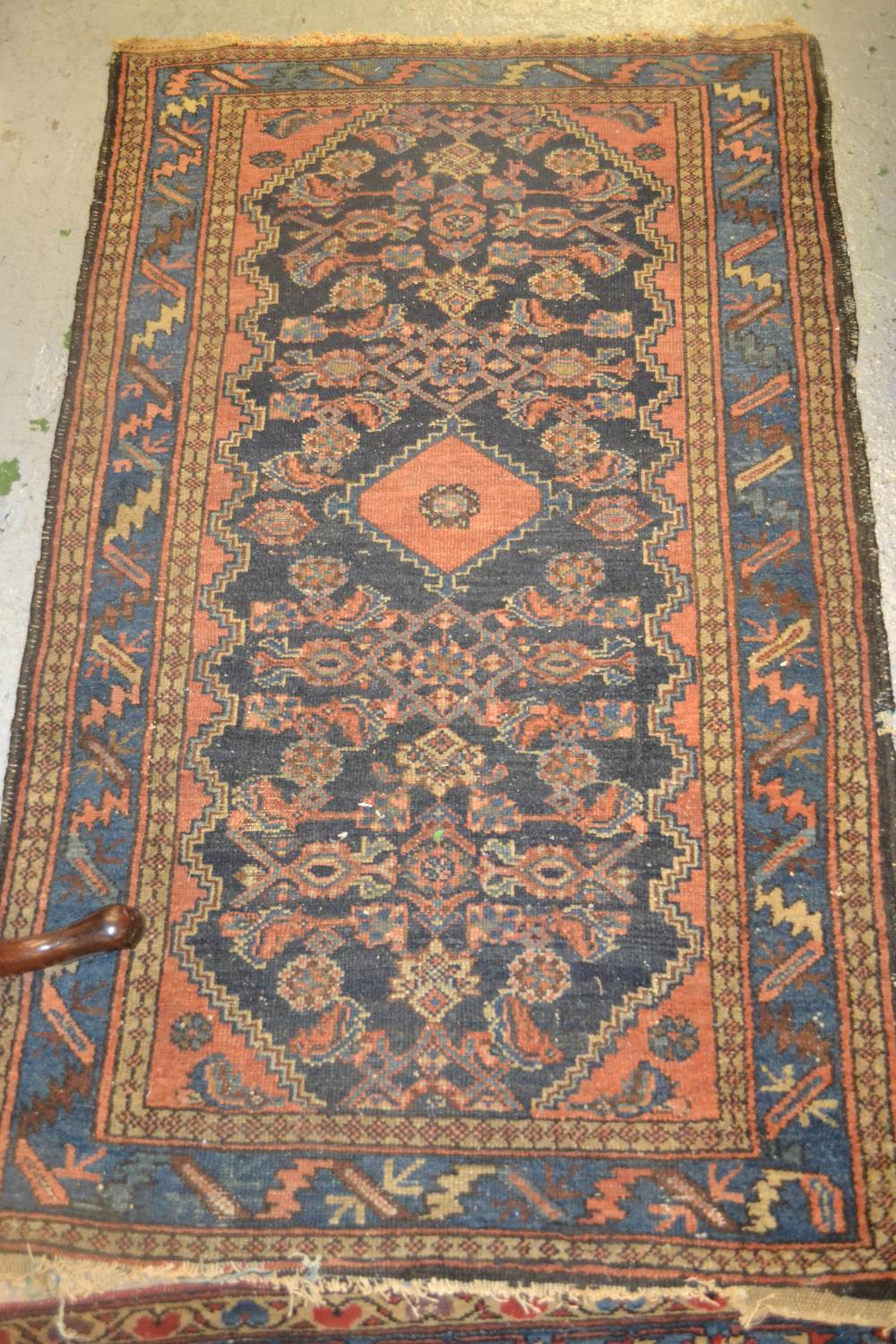Late 19th/early 20th Century rug having various gols and floral decoration on a blue ground with