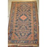 Late 19th/early 20th Century rug having various gols and floral decoration on a blue ground with