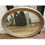 Late 19th / early 20th Century gilt framed oval wall mirror, 31ins x 36ins