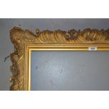 19th Century gilded composition picture frame of rococo design, the aperture approximately 28ins x