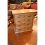 19th Century oak table top collector's chest of four drawers with brass handles on a moulded