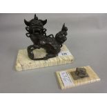 Chinese dark patinated bronze figure of a seated dog of foe on a mammoth tooth base together with