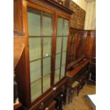 George III mahogany bookcase, the moulded dentil cornice above two astragal glazed doors, the base