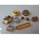 Victorian yellow metal enamel and split pearl circular brooch, gilt metal and garnet set brooch, a