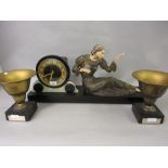Art deco black slate and onyx clock garniture, the center piece surmounted by a gold painted spelter
