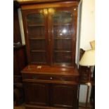 Victorian mahogany bookcase, the moulded cornice above two glazed doors, a long drawer and two panel
