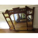 Late 19th Century walnut overmantel mirror having carved spindle top above an arrangement of mirrors