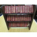 Miniature bookcase containing set of miniature red leather bound volumes, ' Works of Shakespeare '