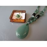 Modern green jade pendant necklace together with a Canadian jade set brooch