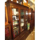 Mahogany bookcase, the moulded cornice above three satinwood crossbanded and astragal glazed