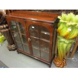 Mid 20th Century mahogany display cabinet with two glazed doors raised on low cabriole supports