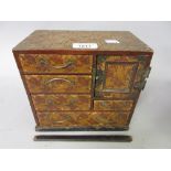 Small Japanese bamboo covered table cabinet with a single door and multiple drawers together with