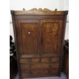 19th Century Irish mahogany linen press, the shaped top above two panelled doors with two short