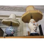 Two Drimmer pottery floral and bird decorated table lamps on hardwood stands with shades