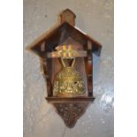 Brass dinner bell on wall mounting carved oak holder