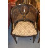 Two 19th Century French carved walnut and parcel gilt bergere chairs raised on turned fluted