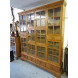 Large mid 20th Century oak bookcase with an arrangement of various small glazed doors and drawers